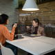 Employees sit behind protective screens as they eat in a cafeteria at the offices of Hyundai Card credit card company in Seoul, South Korea on April 9, 2020.